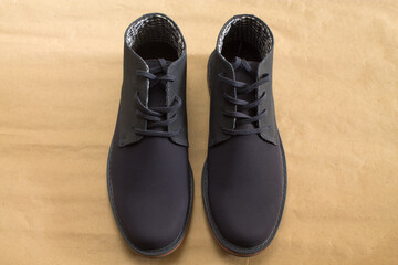 A pair of beautiful blue shoes on a brown background.