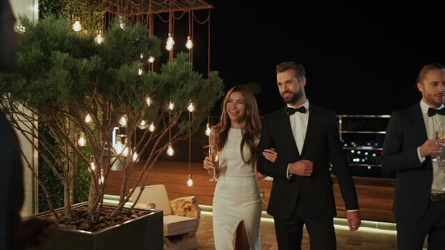 Group of people in formalwear meeting each other on luxury party 