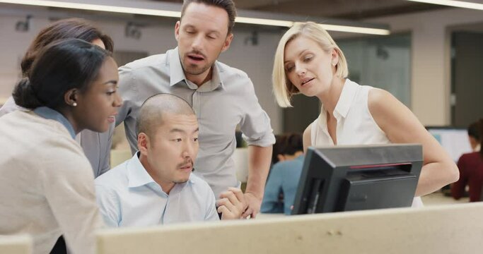Creative business team meeting happy people working in modern office late at night discussing strategy using computer touch screen in diverse gender group