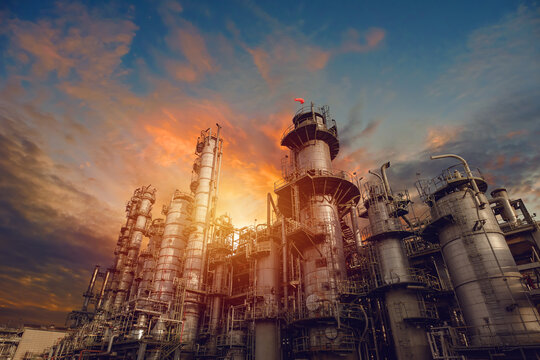 Petrochemical industrial plant on sunset sky background