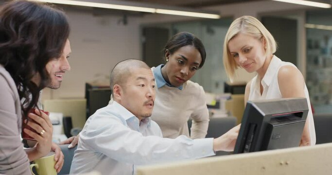 Japanese businessman leading Creative business team meeting.Happy people working in modern office at night discussing strategy using computer touch screen in diverse gender group