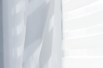 White transparent curtain with white blinds on window.