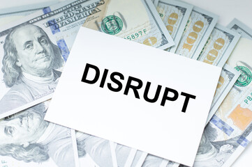 disrupt text on business card which lies on the background of money