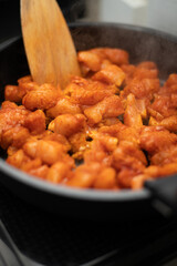 Close up of chicken wings on frying pan