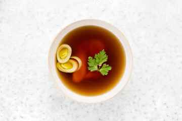 Bone broth in a bowl, top down view