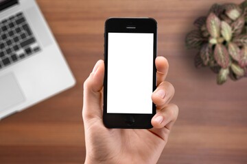 Human hands hold the phone with a blank screen