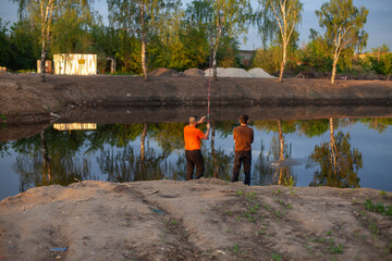 Men are fishing. The guys are fishing with a line.