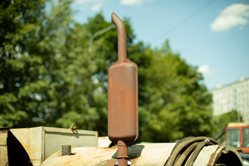 Rusty diesel engine pipe. Muffler on the engine. Rusty metal at the car part.