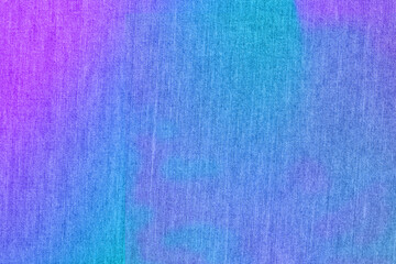Denim with beautiful color transitions: blue, purple, purple. Fabric background.