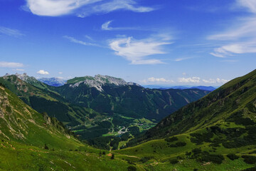 amazing view while hiking to a green valley in austria with blue sky