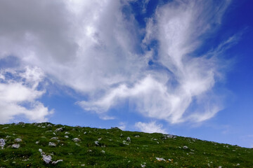 amazing white soft clouds on the blue sky while hiking in the mountains