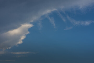 Naklejka na ściany i meble clouds from a storm on blue sky