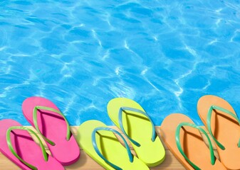 Colored flip flops sitting on the edge of a swimming pool.