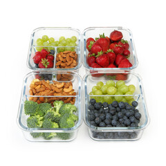 Glass containers with cashews, almonds, grapes, blueberries, strawberries, and broccoli; healthy foods concept