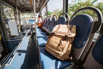 One lost bag or backpack lie on bus seat