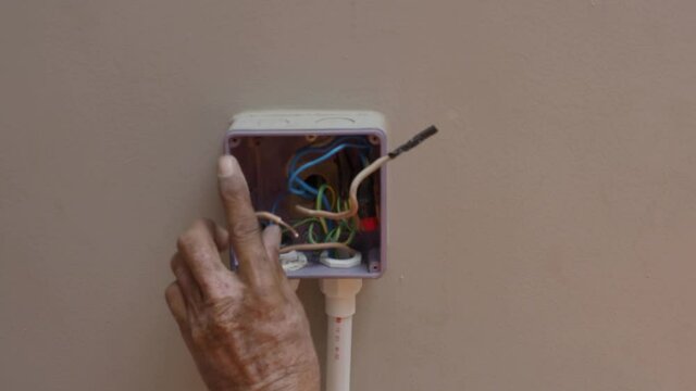 Electrical plug repairs and extension cords by a professional electrician. with equipment such as drills, wires, fuses, floating boxes and conduit wiring. installing wall switches and sockets.
