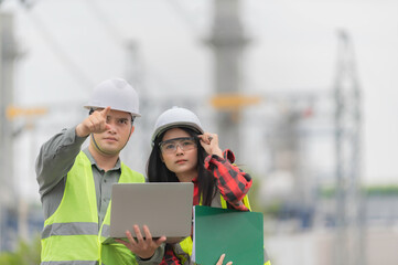 Two engineer working at power plant,Work together happily,Help each other analyze the problem,Consult about development guidelines