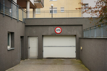 White metallic gate and an LPG sign on the upper side of the wall