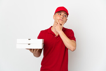 Pizza delivery man with work uniform picking up pizza boxes isolated on white background having...