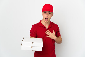 Pizza delivery man with work uniform picking up pizza boxes isolated on white background surprised...