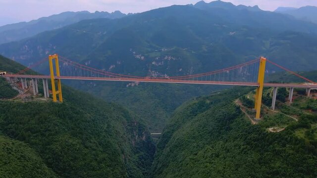 Puli Bridge or Pulihe Bridge is a bridge that crosses the Puli Canyon of the Gesiang River, located in the Qujing City District, China. (aerial photography)