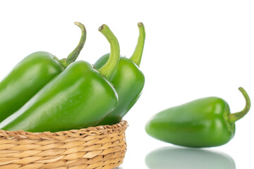 Several green spicy pepper pods with straw dishes, close-up, isolated on white.