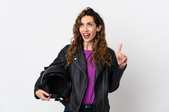 Young caucasian woman holding a motorcycle helmet thinking an idea pointing the finger up