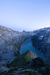 Epic Sunset over an alpine lake called Limmerensee in Switzerland. Wonderful scenery in the alps. The sun shines to the peaks of the mountains. Just amazing.