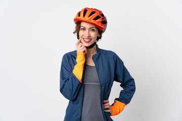 Young cyclist woman isolated on white background thinking an idea while looking up