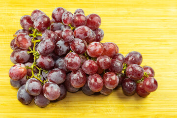 bunch of red grapes on wood