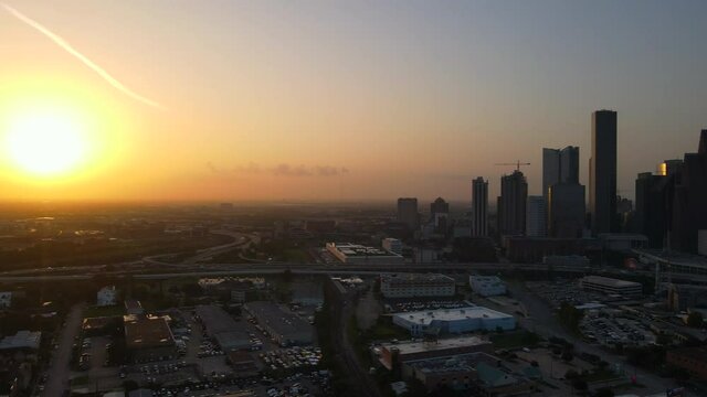 Panning left along Houston skyline toward sunset