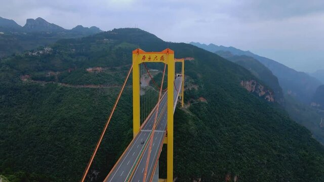 Puli Bridge or Pulihe Bridge is a bridge that crosses the Puli Canyon of the Gesiang River, located in the Qujing City District, China. (aerial photography)