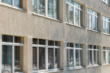 View of the facade of an office building with large Windows. New wide double glazed windows installed in a modern building.