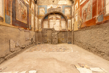 Colorful frescoes on the walls of Collegio Augustali, Herculaneum, Italy.