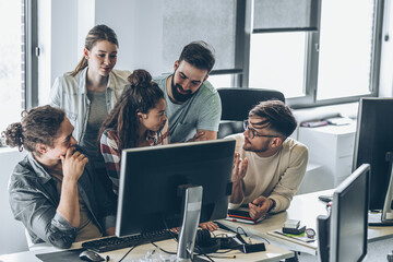 Group of programmers and software developers working on a new project at the office.	
