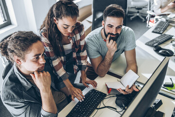 Group of programmers and software developers working on a new project at the office.	
