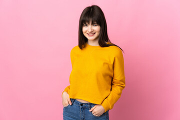 Young Ukrainian woman isolated on pink background laughing