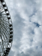 Ferris wheel against sky background, left aligned. 