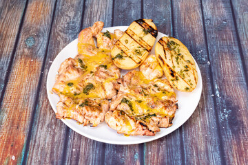 Grilled boneless chicken with honey mustard sauce and halved roast potato with parsley and olive oil
