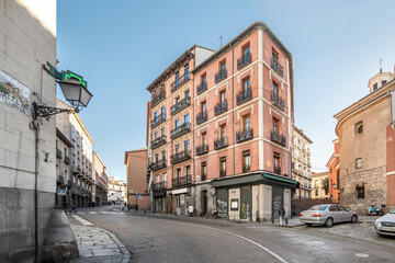Fototapeta na wymiar Vintage buildings on the rise of Segovia street through the historic center of Madrid