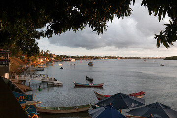 Sunset edge with native boats, Vaza-Barris river, native fishing boats, Joel Silveira bridge in the background