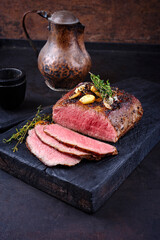Traditional Commonwealth Sunday roast with sliced cold cuts roast beef with garlic and salt as...