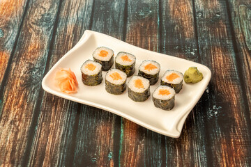 Japanese rice sushi maki roll with Norwegian salmon and nori seaweed with wasabi and ginseng