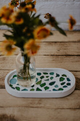 still life with decorative tray, vase and flowers
