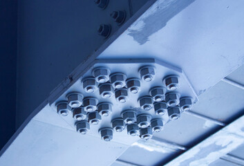 Blue iron beams. Connection of several metal beams in one place. Pedestrian crossing with an iron...
