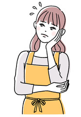 頬に手を当てて考える若い女性