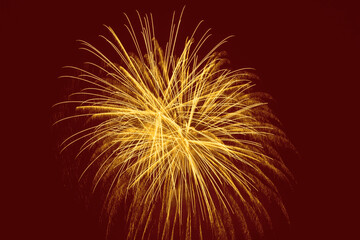 ellow fireworks against dark red background