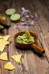avocado dip flavored with garlic, chili, pepper, and lime juice with corn nachos