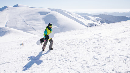 Fototapeta na wymiar man snowboarder at the top of the mountains