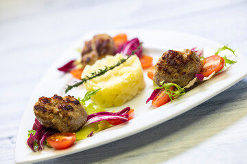 minced veal steaks with mashed potatoes and salad